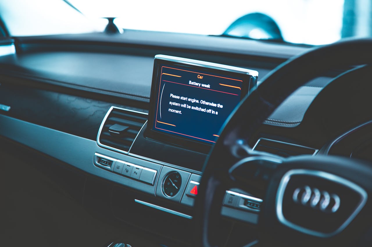 about-us-02 Close-up of a luxury car's interior, showcasing the dashboard and electronic display.